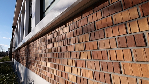 The brick tiles on the facing of the museum's ground floor