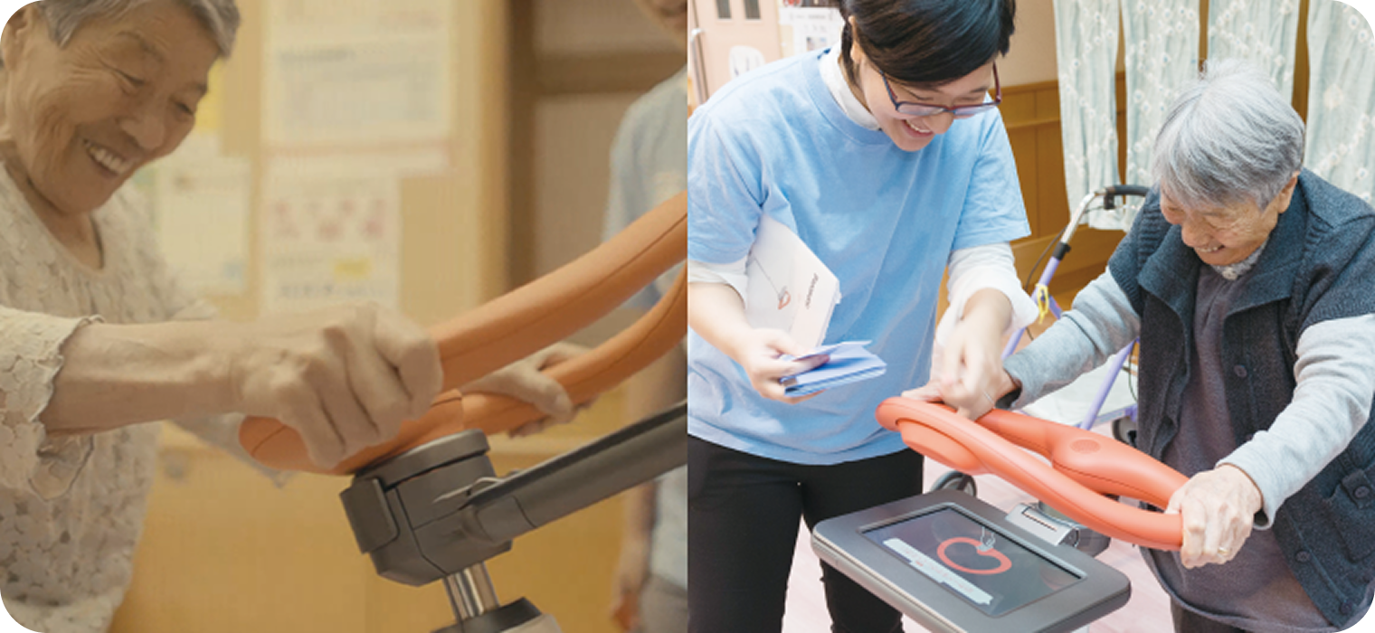 Photo: A smiling user using an improved walk training robot and a and staff member