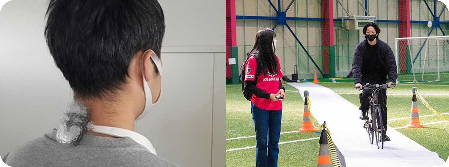 Left photo: A man facing away with a flat, mouse-like prototype device attached to the back of his neck. , Right photo: Photo of early testing at a futsal park. A man on a bicycle approaches from behind on the right. The woman on the left, wearing the Kodekake, notices the approaching bicycle and turns to look behind her.