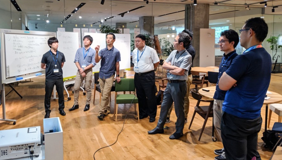 Photo: Members discussing space-related topics in front of a whiteboard