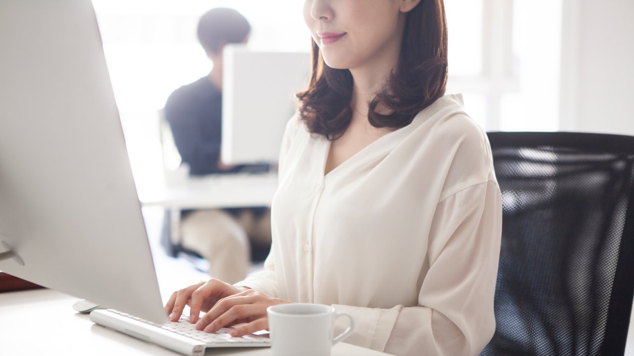 Photo: A woman actively working on a PC
