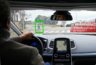 Photo: A pedestrian walking in front of the vehicle is detected and a warning is displayed on the windshield