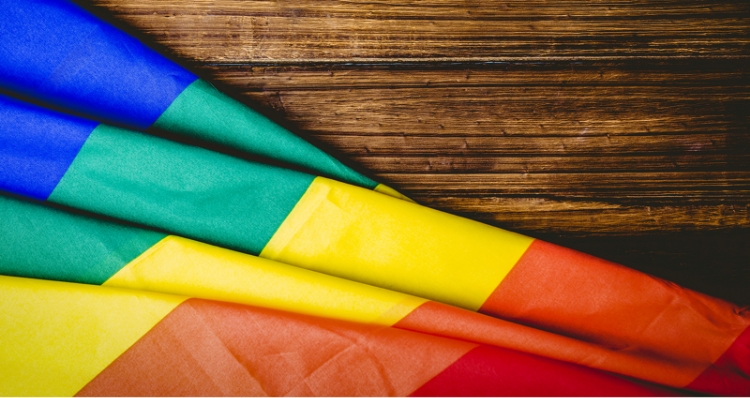 Photo: Flag with a colorful design, featuring blue, green, yellow, red, and other colors.