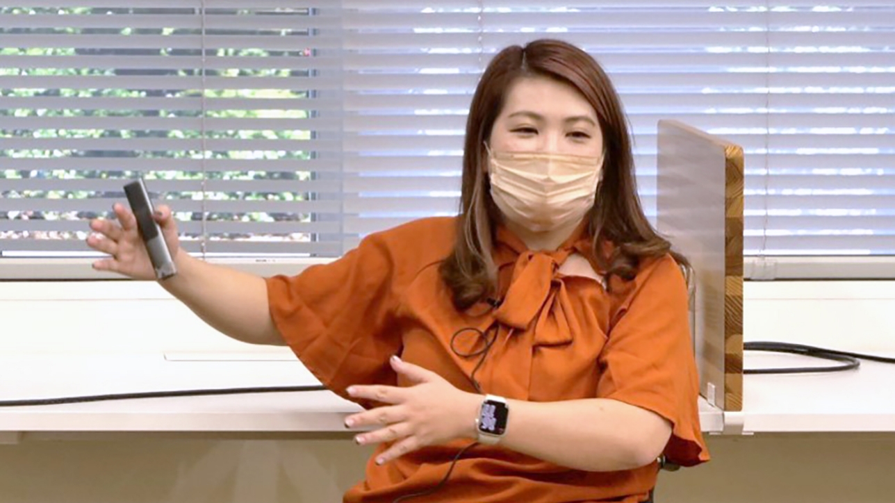 Photo: Eri Yamamoto gesturing with her hands as she addresses the participants.