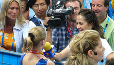 Photo: Cameraperson using a camera recorder to film an athlete being interviewed at one of the venues of the Olympic Games Athens 2004