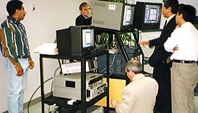 Photo: Panasonic engineers using multiple monitors and equipment to check slow motion images