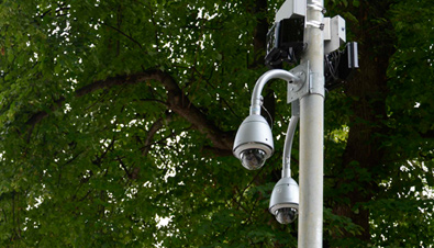 Photo: Outdoor security cameras with housing installed on a post outdoors