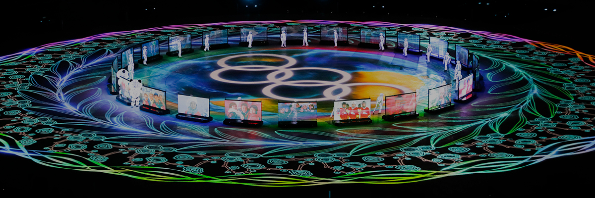 Photo of the PyeongChang 2018 Winter Games Closing Ceremony featuring bright, colorful light from the 30,000-lumen laser projector