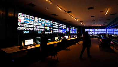 Photo of video editing operations at the International Broadcast Centre using multiple monitors