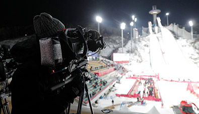 Photo of a broadcast cameraman using an HD camera recorder in freezing conditions at the PyeongChang 2018 Winter Games ski jump venue
