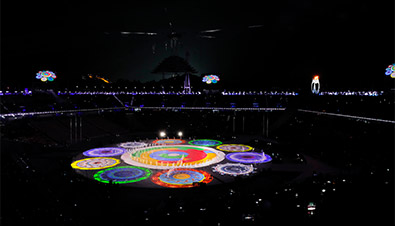 Photo of the PyeongChang 2018 Winter Games Closing Ceremony featuring bright, colorful light from the high brightness laser projector