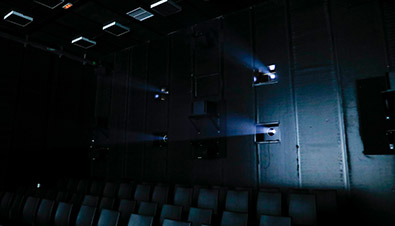 Photo of light beamed from four PT-RQ32K laser projectors at the NHK 8K theater inside the IBC