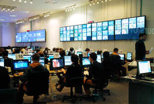 照片：在里约奥运会IBC（国际广播中心）工作人员使用多台显示器进行工作的情景