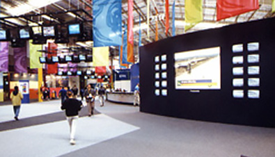 Photo: Live images of the competitions being shown on displays installed at the booth of the International Broadcast Center (IBC) for the Olympic Games Sydney 2000